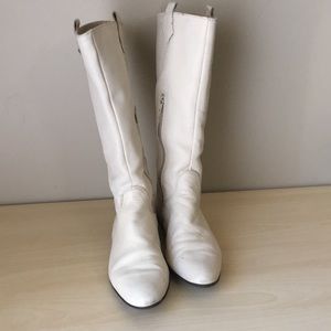 Cream colored calf high leather boots.